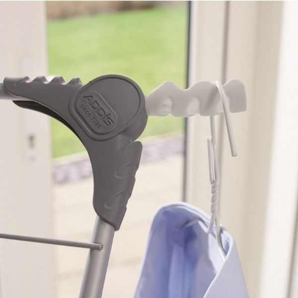 Clothing rack with grey clip that turns into a hook to hang washing.