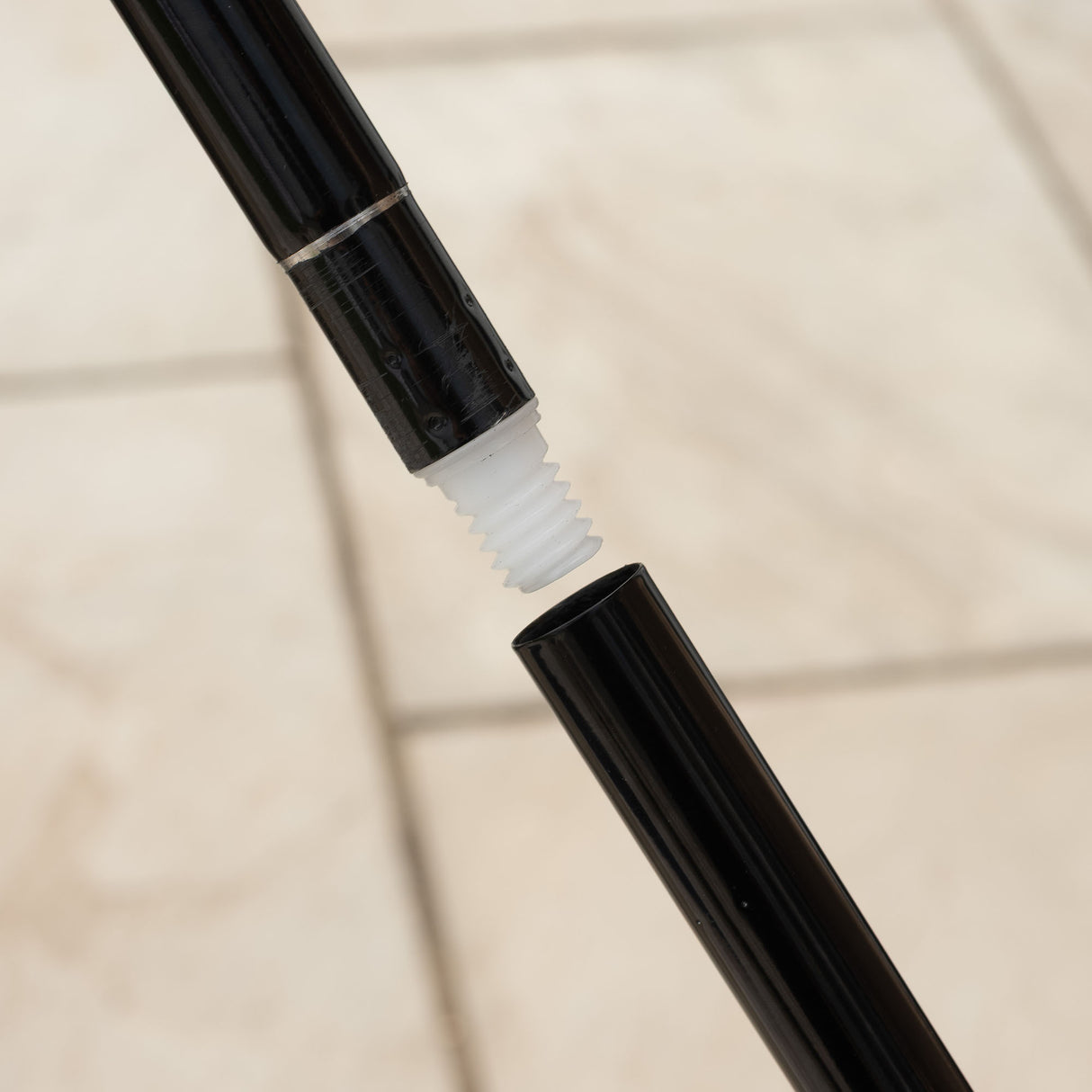 Close-up of pole being screwed together