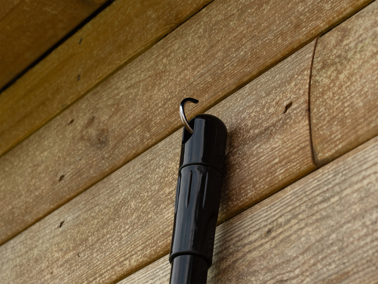 Broom handle hooked onto a wall fixture