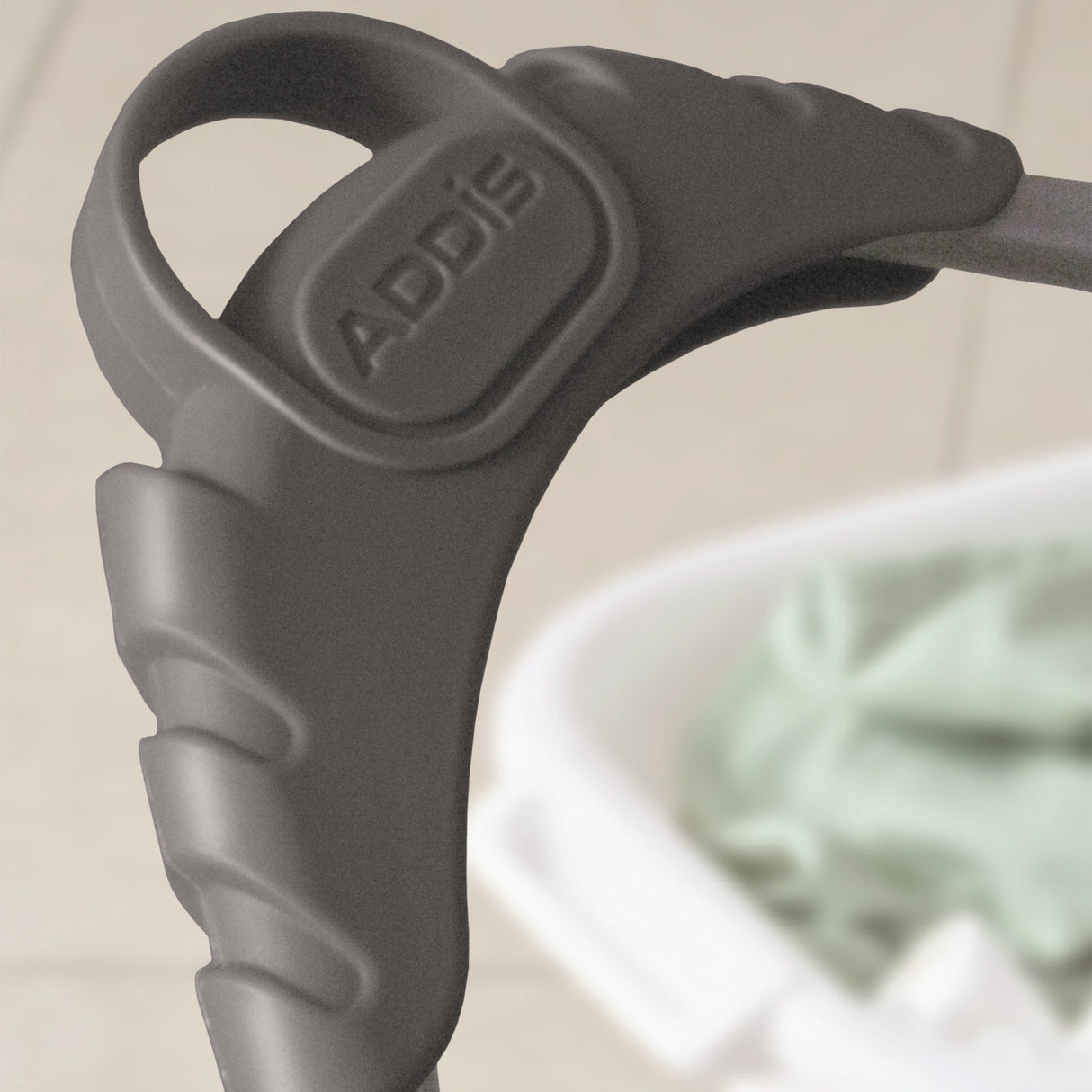 Close-up of a grey plastic handle with Addis branding on it.