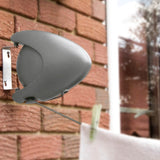 Outdoor Retractable Line attached to a wall with the washing line in use with a white towel pegged on to the line.