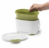 White 2.5L compost caddy with the green inner bucket being removed for easy emptying and cleaning.