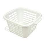 A cream square laundry basket with a solid pattern and handles on the sides.