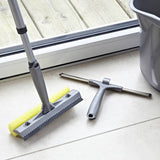 Window cleaner next to a squeegee and a bucket ready for window cleaning