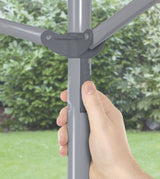 Thumb pushing the height adjustment below the arms, top of the pole