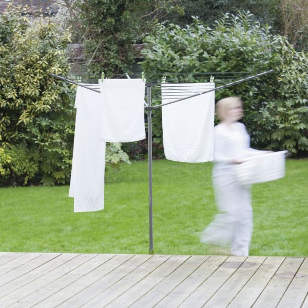 Person hanging white laundry onto the 35m rotary airer