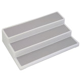 A white base three-tier shelf organiser with grey panels for each tier. 
