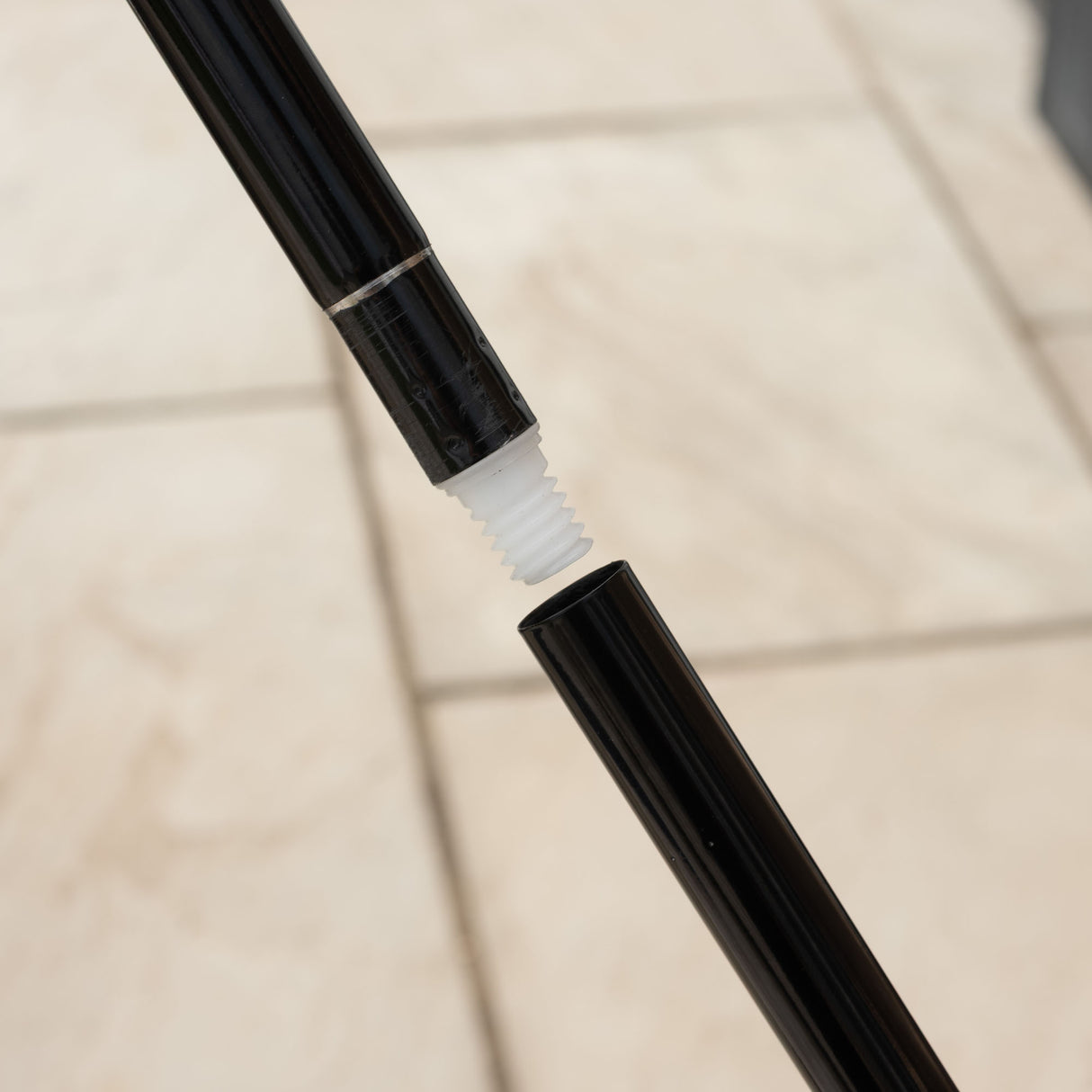 Close-up of a broom pole's screw-in mechanism